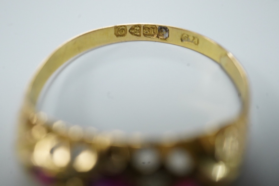 A ruby and diamond ring, circa 1916, set with three circular-cut rubies, spaced by pairs of circular-cut diamonds, mounted in 18ct gold, size R1/2, British hallmarks, gross weight approximately 2 grams, one ruby syntheti
